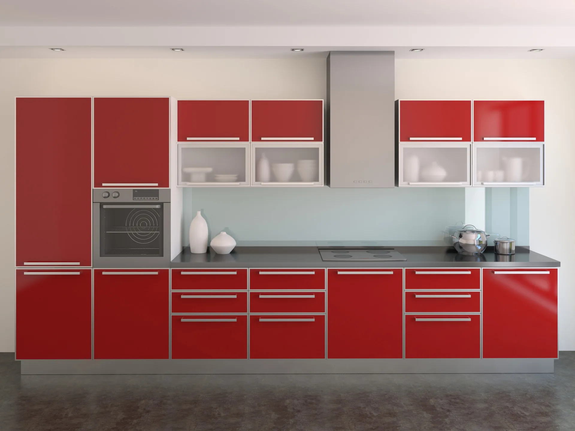 A contemporary kitchen features high-gloss red cabinets, a solid pale blue backsplash, black countertops, and integrated stainless steel appliances.