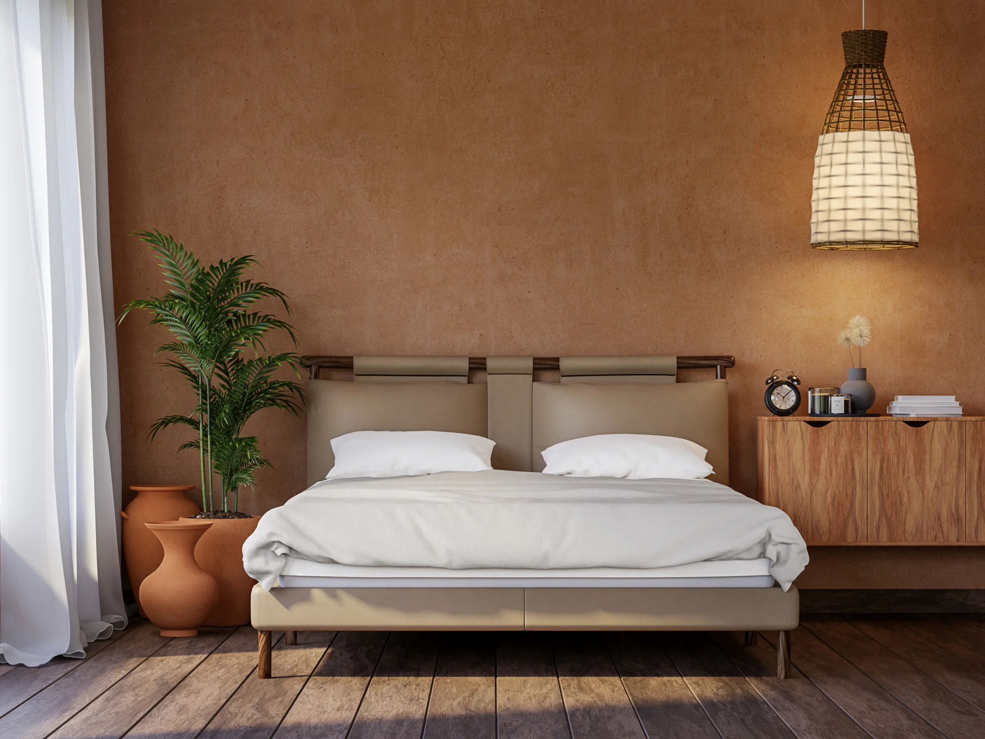 An upholstered beige bed is positioned against a textured terracotta wall next to a wooden cabinet, a green plant in a pot, and a woven pendant light.