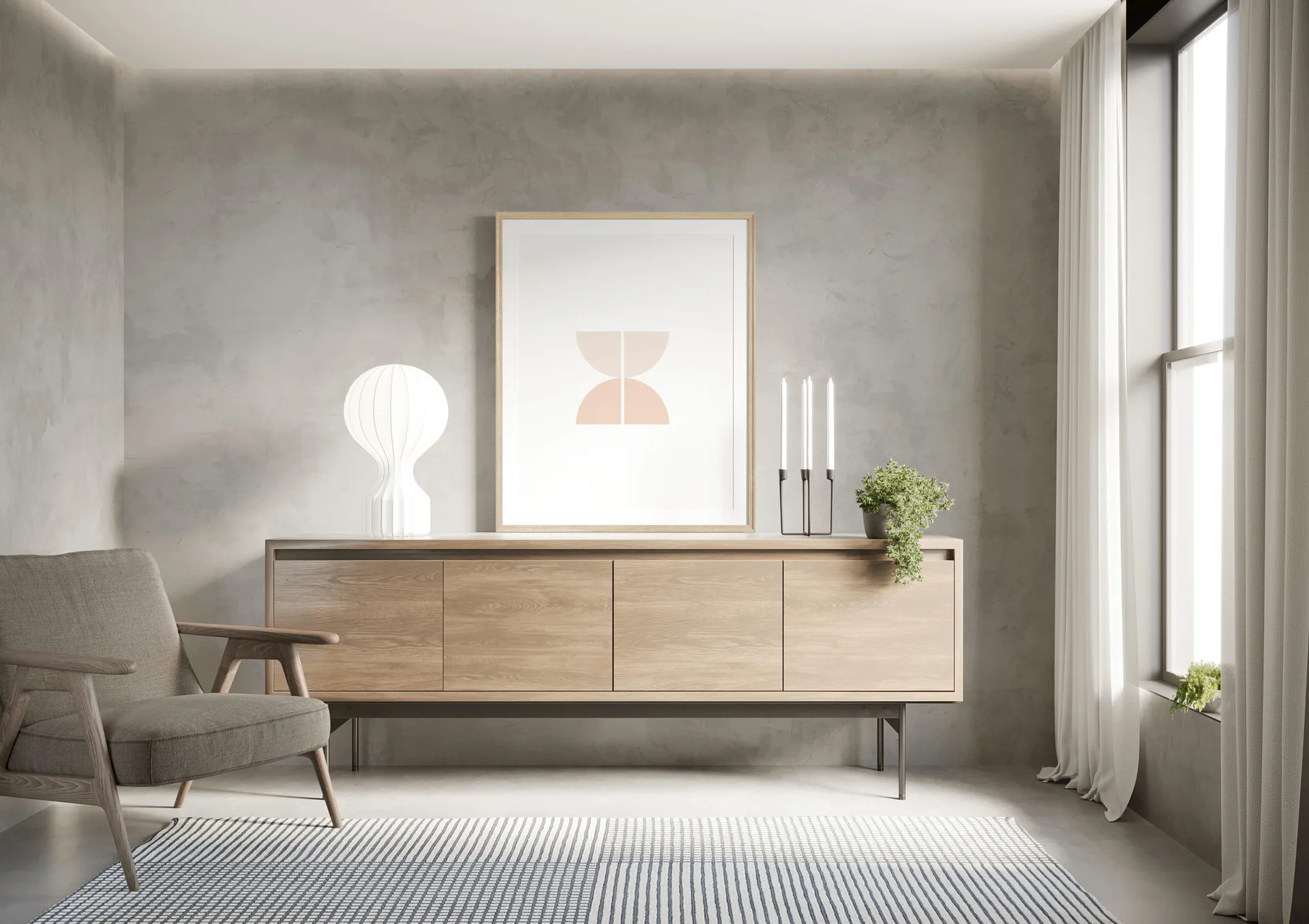 A minimalist room featuring a light wood sideboard, textured grey plaster walls, a grey armchair, and a large framed abstract print.